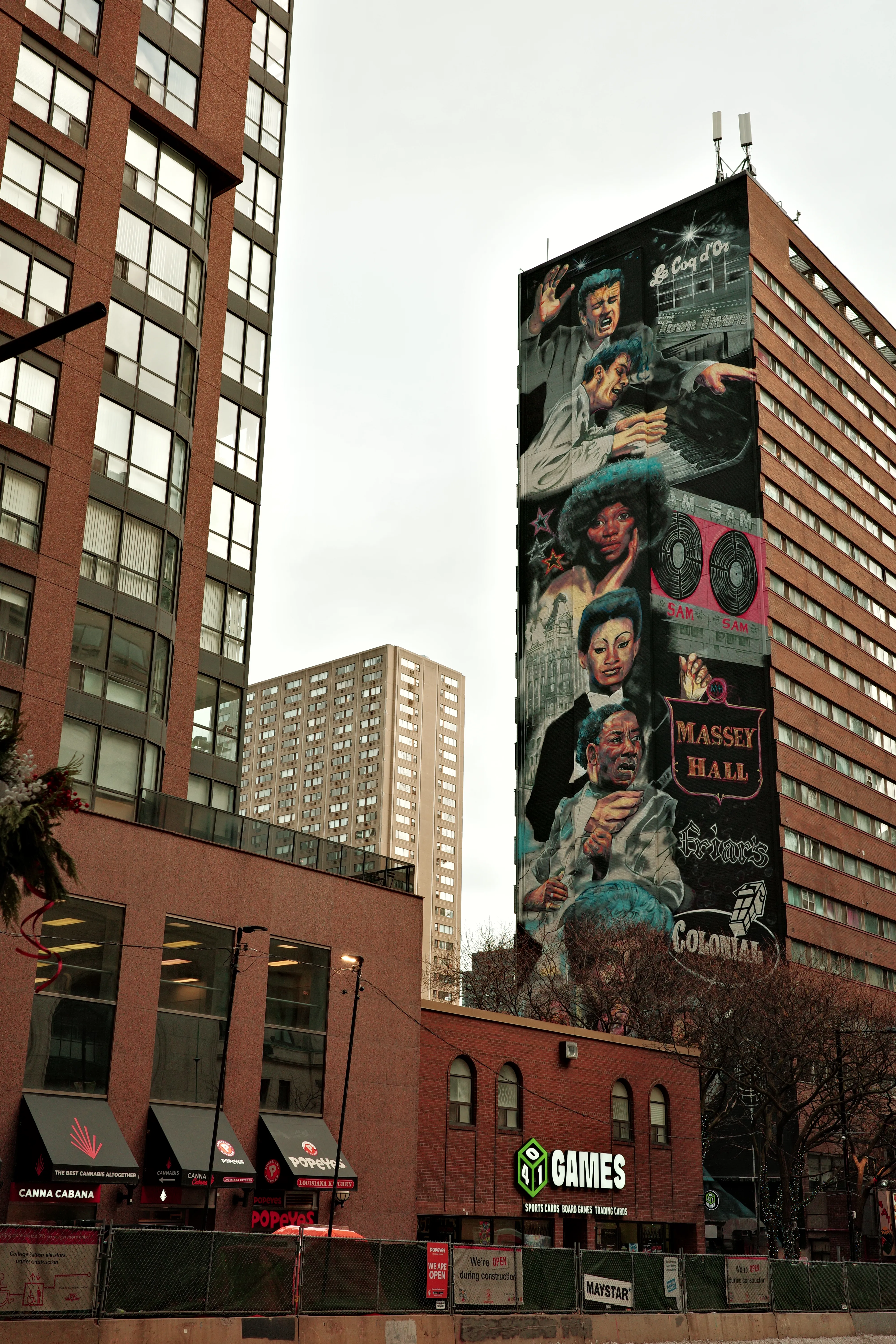 Photo of a mural of Massey Hall musicians on the side of a building downtown Toronto