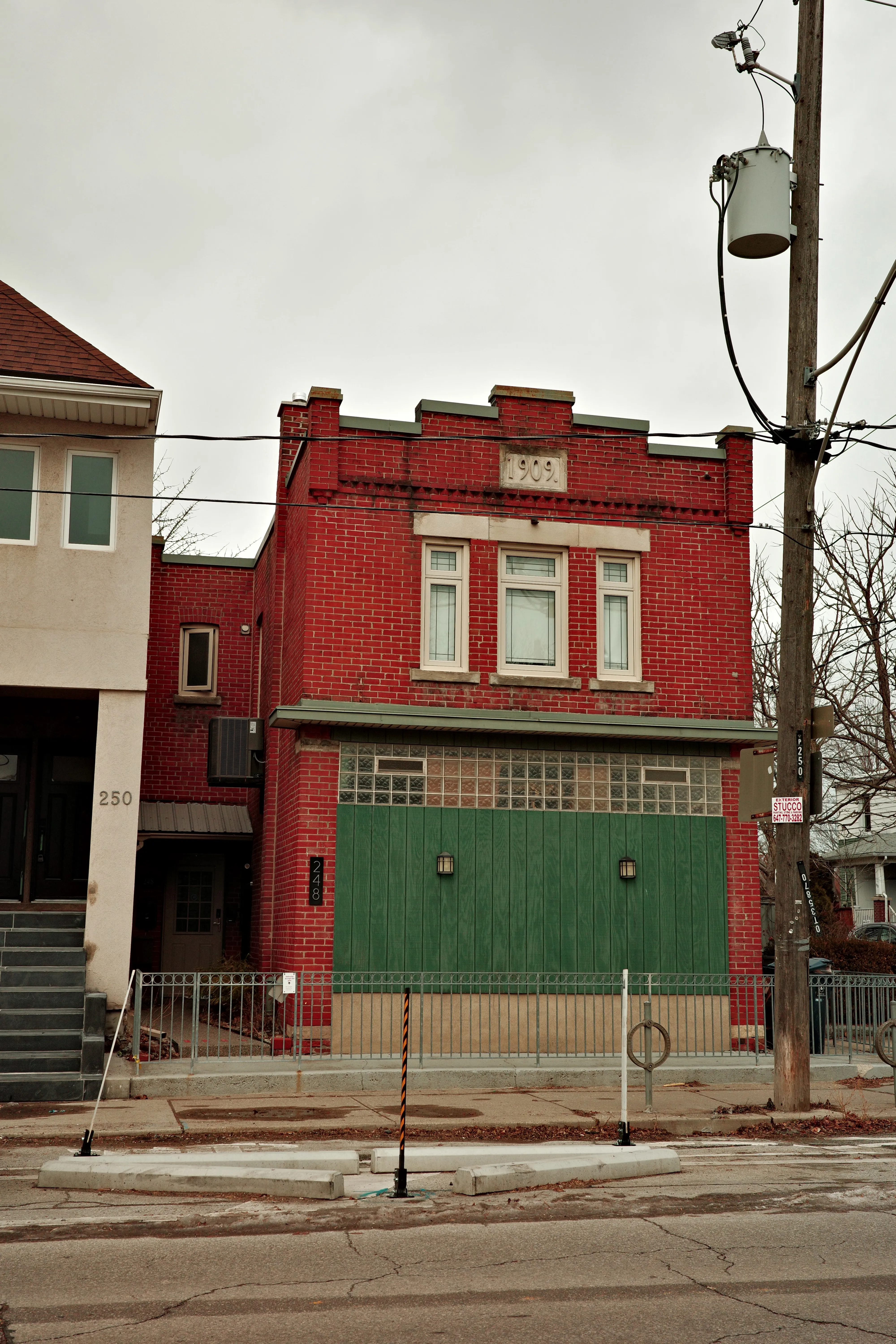 Photo of a red brick building with green accents