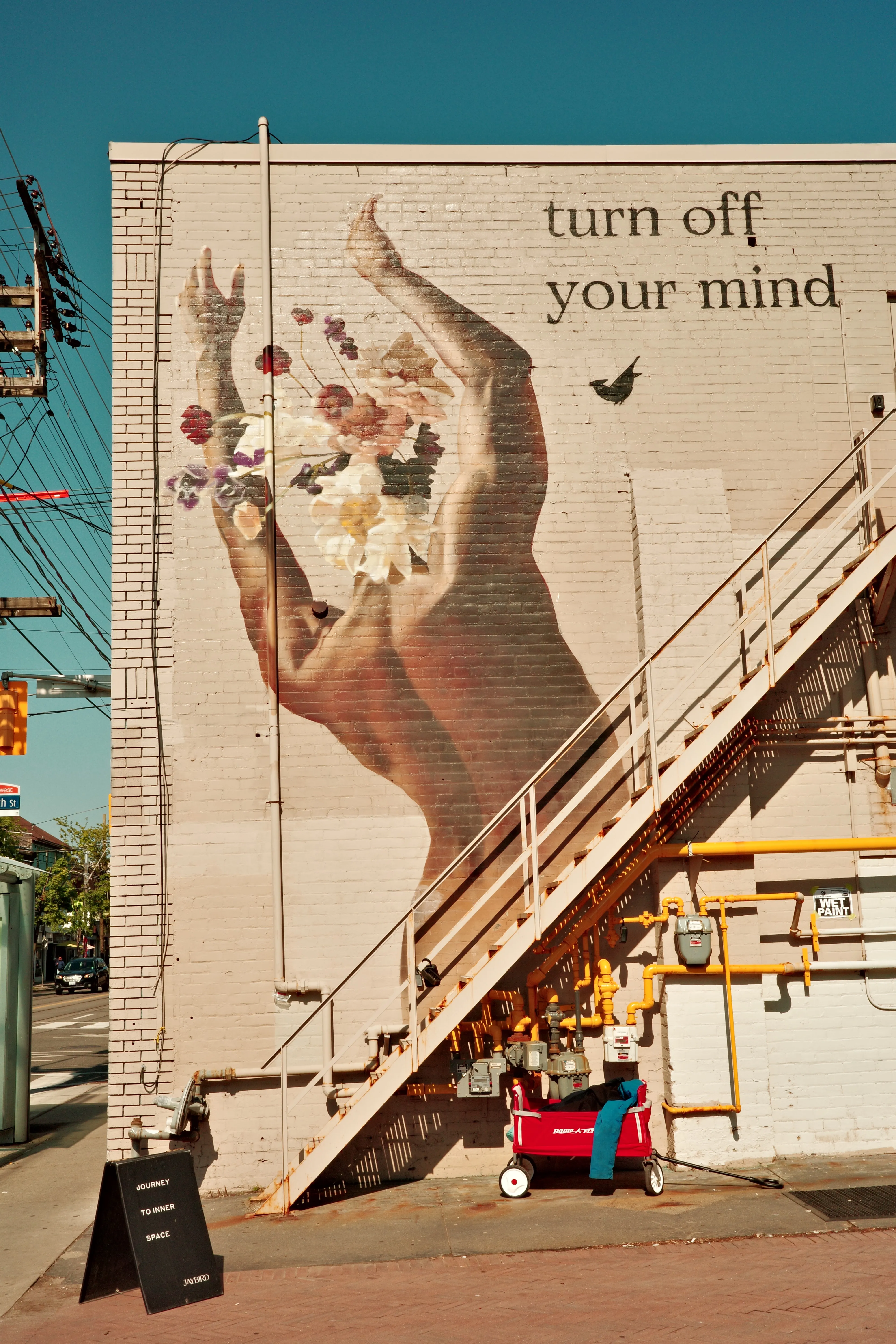 Photo of mural that says "turn off your mind"